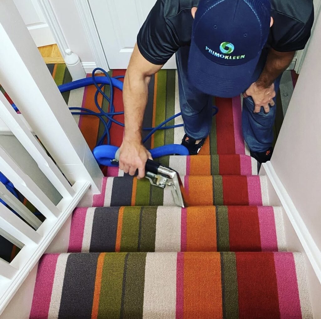 Ed the owner of Primokleen, cleaning striped stairs in a Maidenhead home.